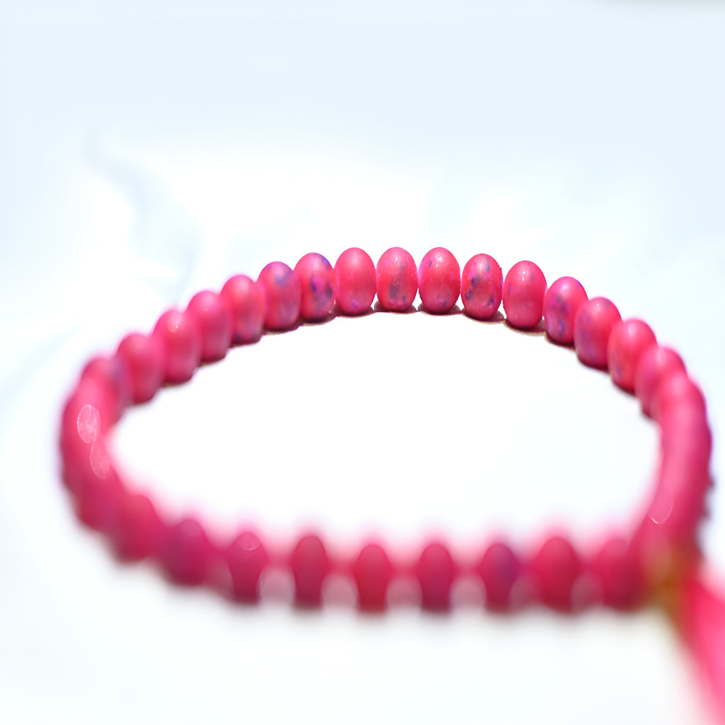 Zamzam Zarqun LLC prayer beads with intricate design, displayed on a prayer mat for spiritual practice and meditation.