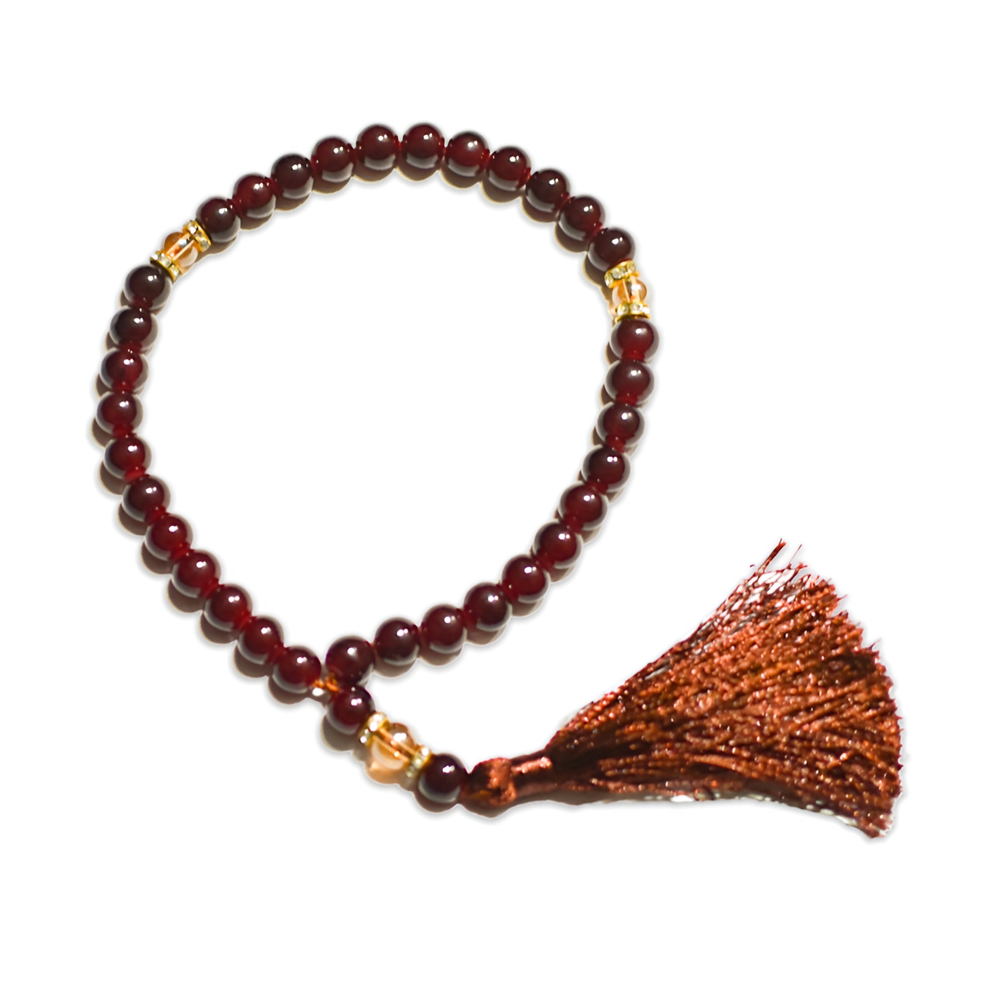 Zamzam Zarqun LLC Maqtab Grace prayer beads with black and gold accents on a prayer rug.